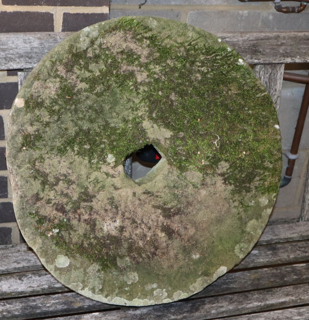 A natural stone millstone, diameter 58cm
